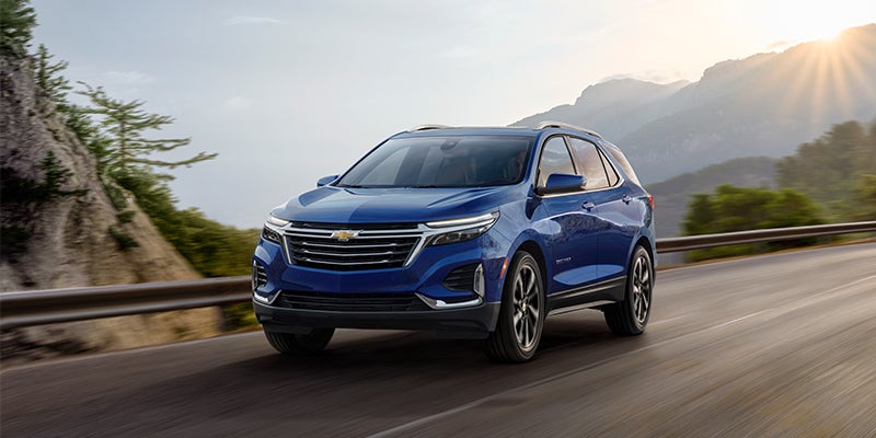 Blue Chevy Equinox Driving Down a Road